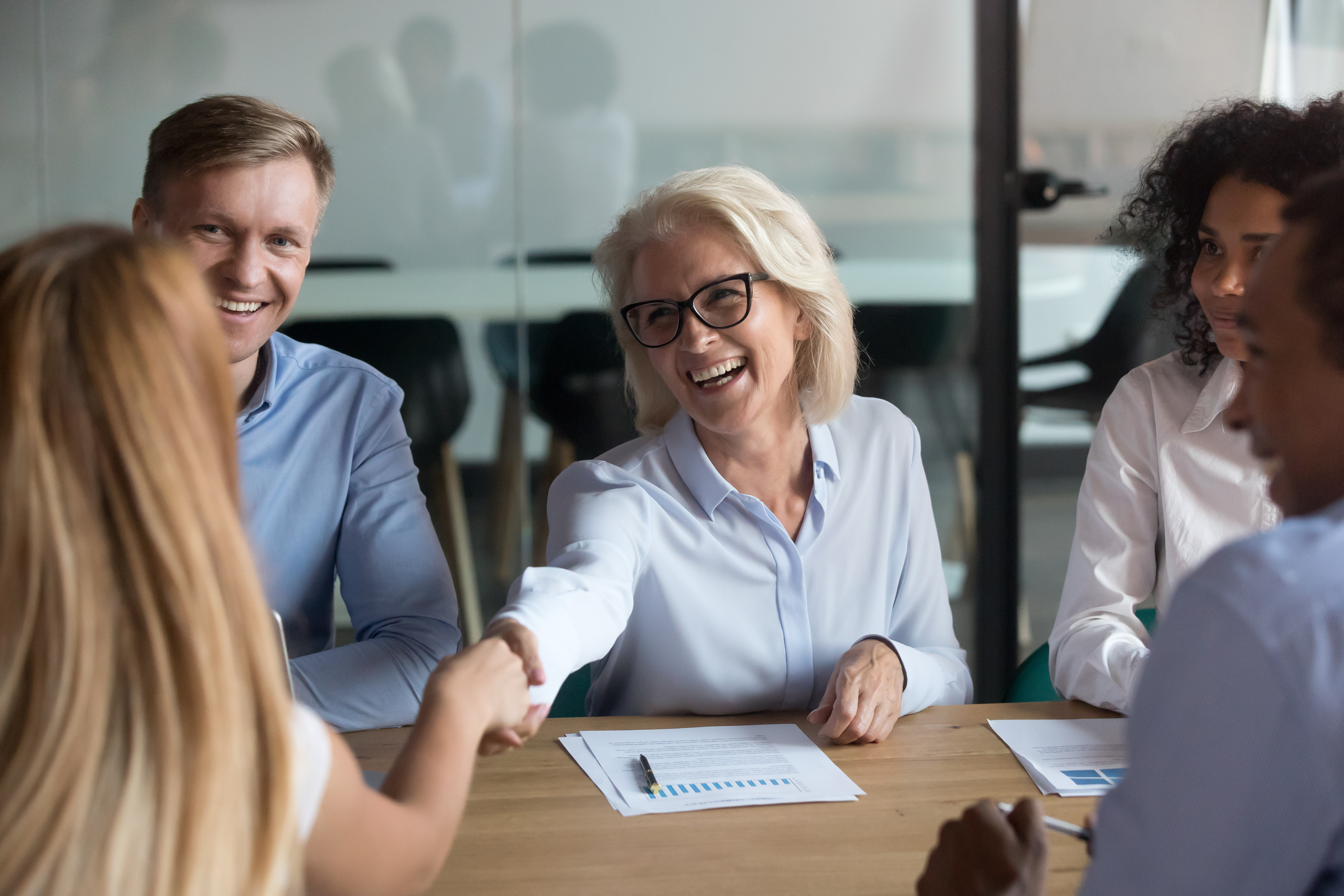 Broker reviewing employee benefits education materials with an employer group supporting the broker and client relationship